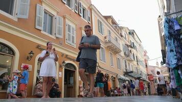 Greece Corfu island 05.23.2024 Real streets Travelers tourists walking looking at the sights ancient buildings famous squares video