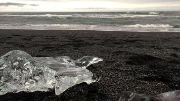 Diamond Beach with sparkling icebergs set against the backdrop of a turbulent northern sea video