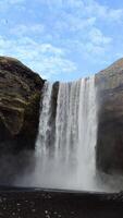 A wide vertical view of the towering Skogafoss waterfall in Iceland. video