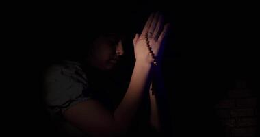 Woman Practicing Her Faith Praying In The Dark video