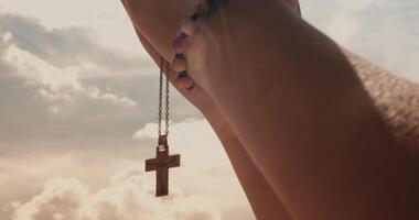 Woman praying against a blue sky in the afternoon video