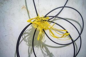 a coil of intricate cable tied with plastic rope or raffia photo