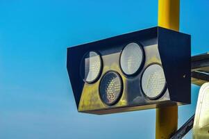 railway crossing signal lights with bright blue sky copy space background photo