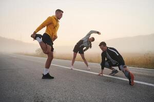 Diverse Athletes Prepare. Dynamic Group Warms Up for Morning Run. photo