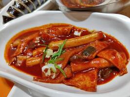 a plate of tteokbokki with gocujang sauce. perfect for menu and food content photo