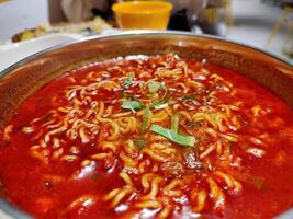 a pot filled with ramyeon or Korean noodles. perfect for menu and food content photo