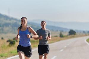 Energized by the beauty of nature, a couple powers through their morning run, their bodies and spirits invigorated. photo