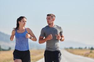 Energized by the beauty of nature, a couple powers through their morning run, their bodies and spirits invigorated. photo