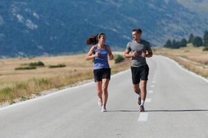 Energized by the beauty of nature, a couple powers through their morning run, their bodies and spirits invigorated. photo