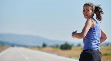 A determined woman athlete trains for success in the morning sun. photo