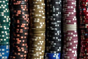 A large number of multi-colored poker chips. Big wins and excitement of the game photo