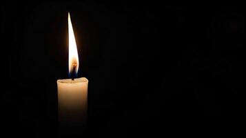 Burning white candle on black background. Close-up photo. With copy space. Image for memory of events and people photo