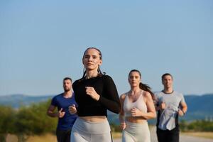 A group of friends maintains a healthy lifestyle by running outdoors on a sunny day, bonding over fitness and enjoying the energizing effects of exercise and nature photo