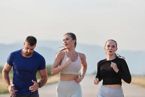 A group of friends maintains a healthy lifestyle by running outdoors on a sunny day, bonding over fitness and enjoying the energizing effects of exercise and nature photo