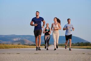 A group of friends maintains a healthy lifestyle by running outdoors on a sunny day, bonding over fitness and enjoying the energizing effects of exercise and nature photo