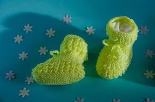 Knitted children's socks booties made of soft yellow thread photo