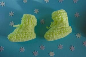 Knitted children's socks booties made of soft yellow thread photo