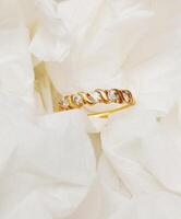 a gold ring on a white background photo