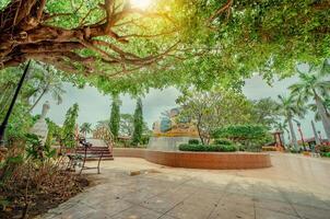 Traditional park of Nagarote, Nicaragua. A relaxed park with a wooden bridge over a water fountain, Beautiful Nagarote central park on sunny day photo