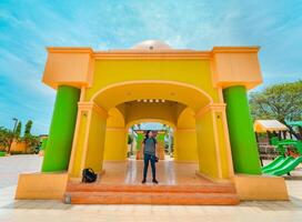 Young tourist in the central park of Nagarote, Nicaragua. Portrait of tourist at the colorful monument of Nagarote park photo