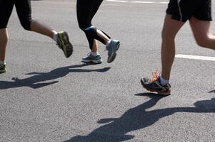 marathon runners running on asphalt photo