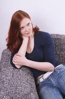 young woman relaxing on couch or sofa photo