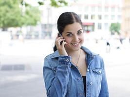 young woman holding mobile phone to her ear photo