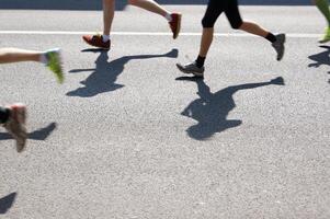 marathon runners running on asphalt photo