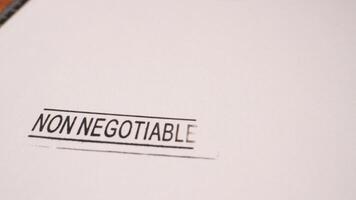 1 photo of black non negotiable stamp inscription on white paper