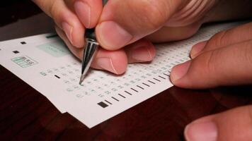 3 close up Hispanic male filling out multiple choice exam student testing paper photo