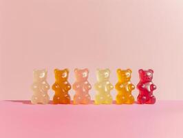 Multicolored gummy bears isolated on a pink background. Aesthetic macro photography photo