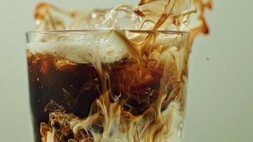 Iced cold brew coffee with cream swirling photo