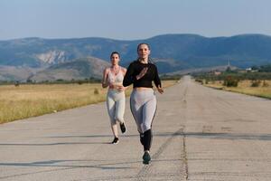 A group of friends maintains a healthy lifestyle by running outdoors on a sunny day, bonding over fitness and enjoying the energizing effects of exercise and nature photo