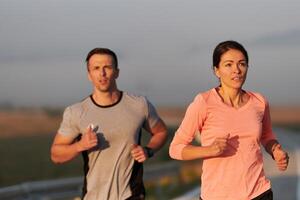 Energized by the beauty of nature, a couple powers through their morning run, their bodies and spirits invigorated. photo