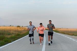 A group of friends, athletes, and joggers embrace the early morning hours as they run through the misty dawn, energized by the rising sun and surrounded by the tranquil beauty of nature photo