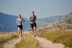 Energized by the beauty of nature, a couple powers through their morning run, their bodies and spirits invigorated. photo