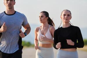 A group of friends maintains a healthy lifestyle by running outdoors on a sunny day, bonding over fitness and enjoying the energizing effects of exercise and nature photo