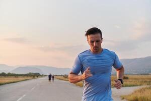 A group of friends maintains a healthy lifestyle by running outdoors on a sunny day, bonding over fitness and enjoying the energizing effects of exercise and nature photo