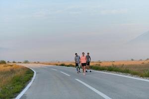 A group of friends, athletes, and joggers embrace the early morning hours as they run through the misty dawn, energized by the rising sun and surrounded by the tranquil beauty of nature photo