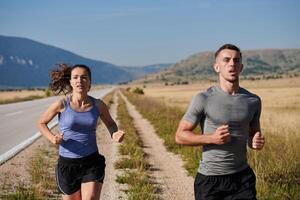 Energized by the beauty of nature, a couple powers through their morning run, their bodies and spirits invigorated. photo