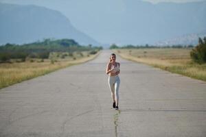 A determined woman athlete trains for success in the morning sun. photo