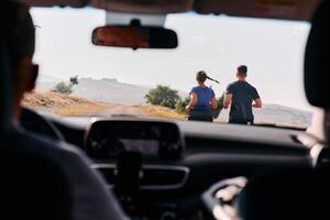 Romantic Couple Running Outside, Captured from Car photo