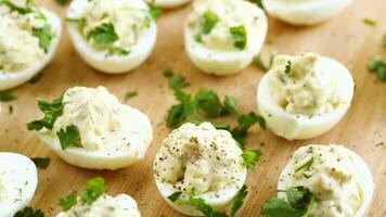 stuffed eggs, deviled eggs on a wooden table video