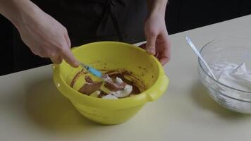 Woman's hands shuffle chocolate dough video