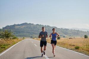 Energized by the beauty of nature, a couple powers through their morning run, their bodies and spirits invigorated. photo