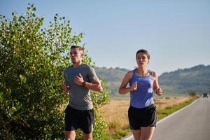 Energized by the beauty of nature, a couple powers through their morning run, their bodies and spirits invigorated. photo