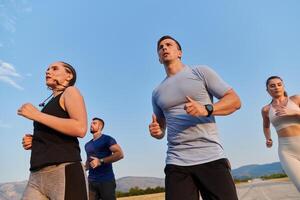 A group of friends maintains a healthy lifestyle by running outdoors on a sunny day, bonding over fitness and enjoying the energizing effects of exercise and nature photo