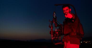 Nighttime Capture. Professional Videographer Films Athletes Running in Red-Lit Darkness photo