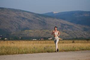 A determined woman athlete trains for success in the morning sun. photo