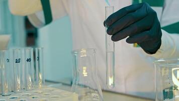 A close-up of adding a drop of a chemical reagent to a test tube with a dispenser. Work in the Laboratory with test tubes and medicines video